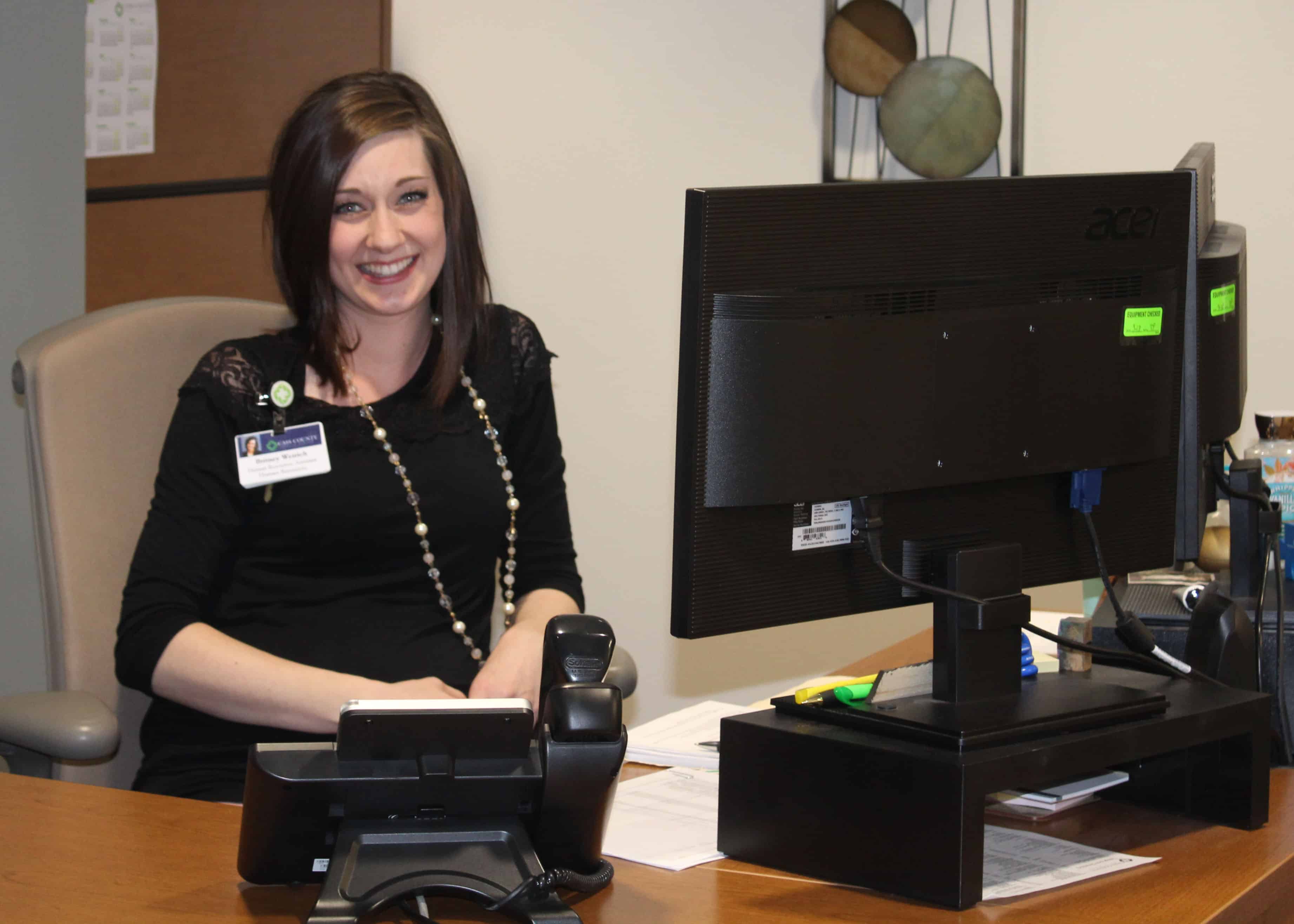 Britney Weirich sitting at desk