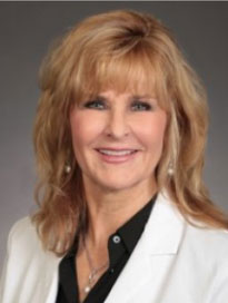 Robin-Westrum woman wearing white jacket and smiling at the camera