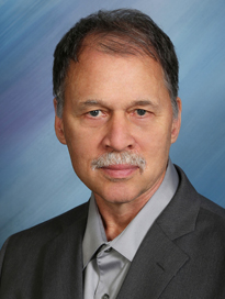 man wearing black suit jacket looking at camera