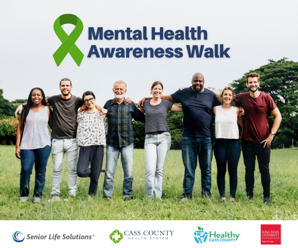 Diverse group standing in grass with arms around each other. text above says Mental Health Awareness walk, and sponsor logos under.